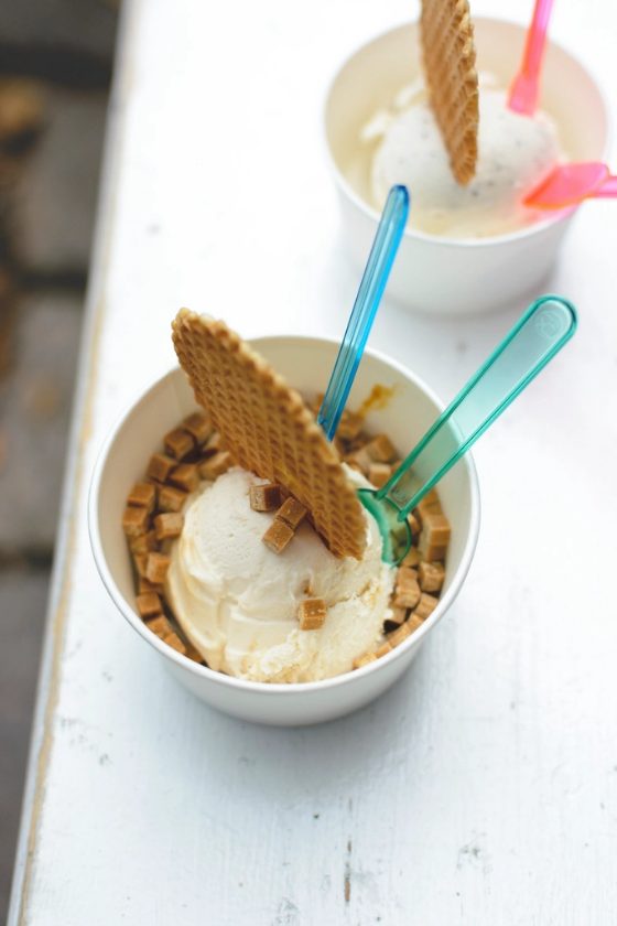 Vanilleeis mit Karamellstücken und einem Stück Waffel im Becher